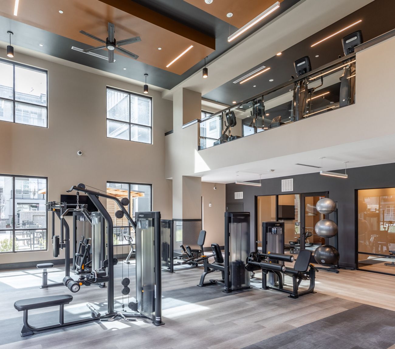 Fitness center with cardio and weight machines at McEwen Northside Apartments