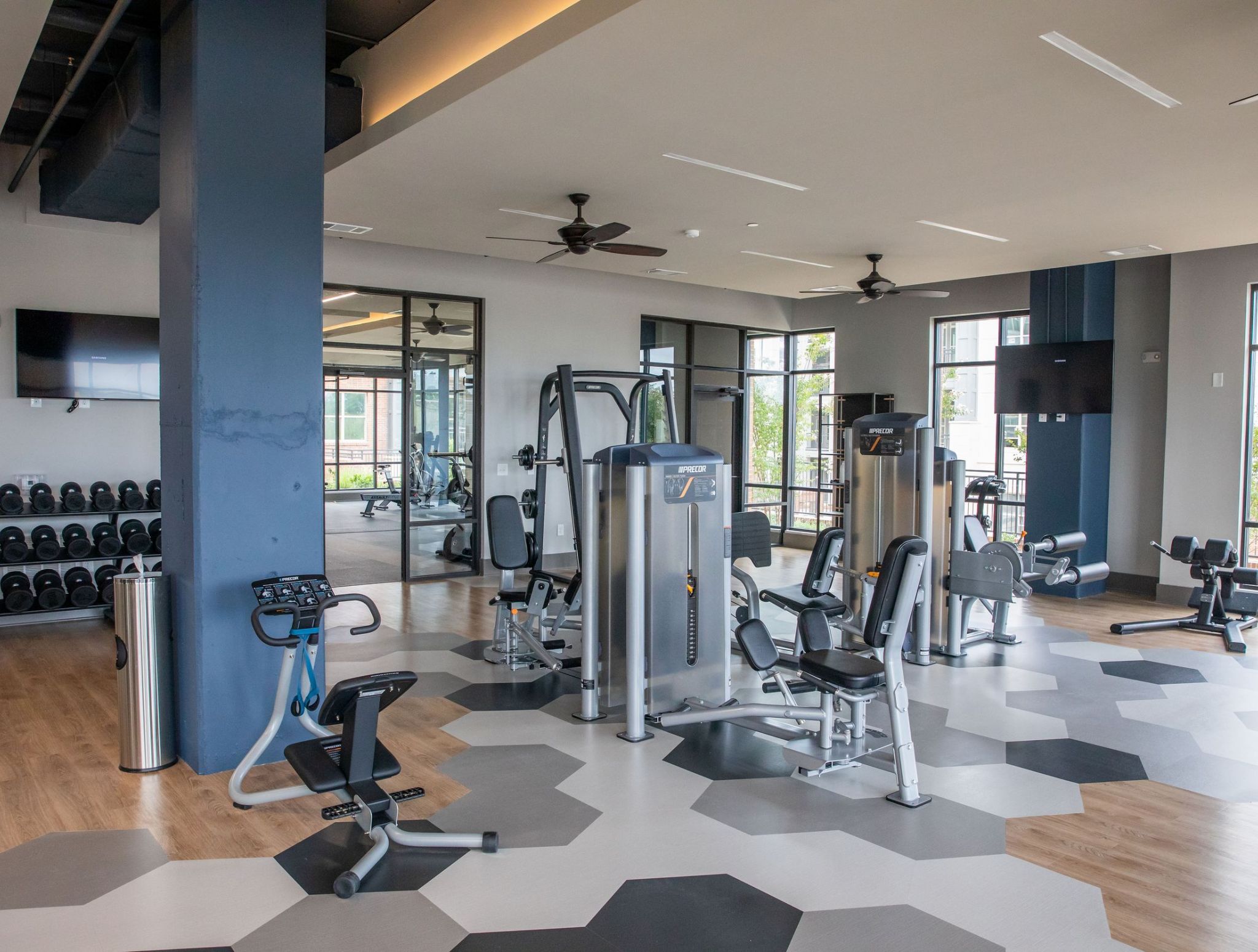 Fitness center with cardio and weight machines at McEwen Northside Apartments