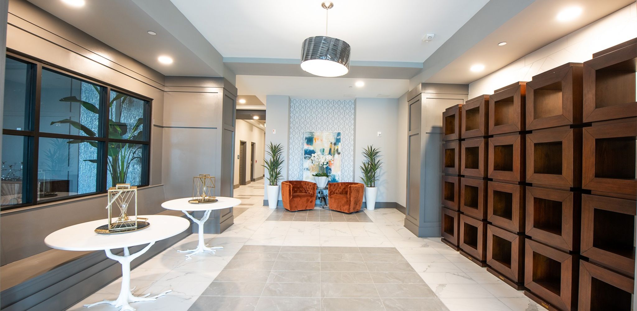 McEwen Northside Apartments lobby area with two chairs and a wide hallway