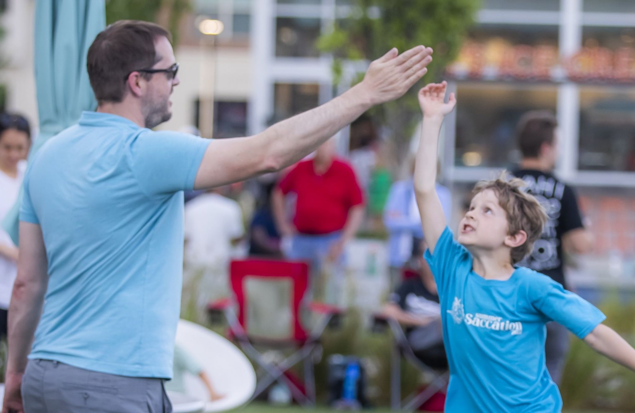 Man giving young boy a high five