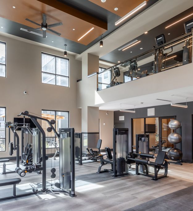 Cardio machines, including Peloton, Stairway, and elliptical at McEwen Northside Apartments
