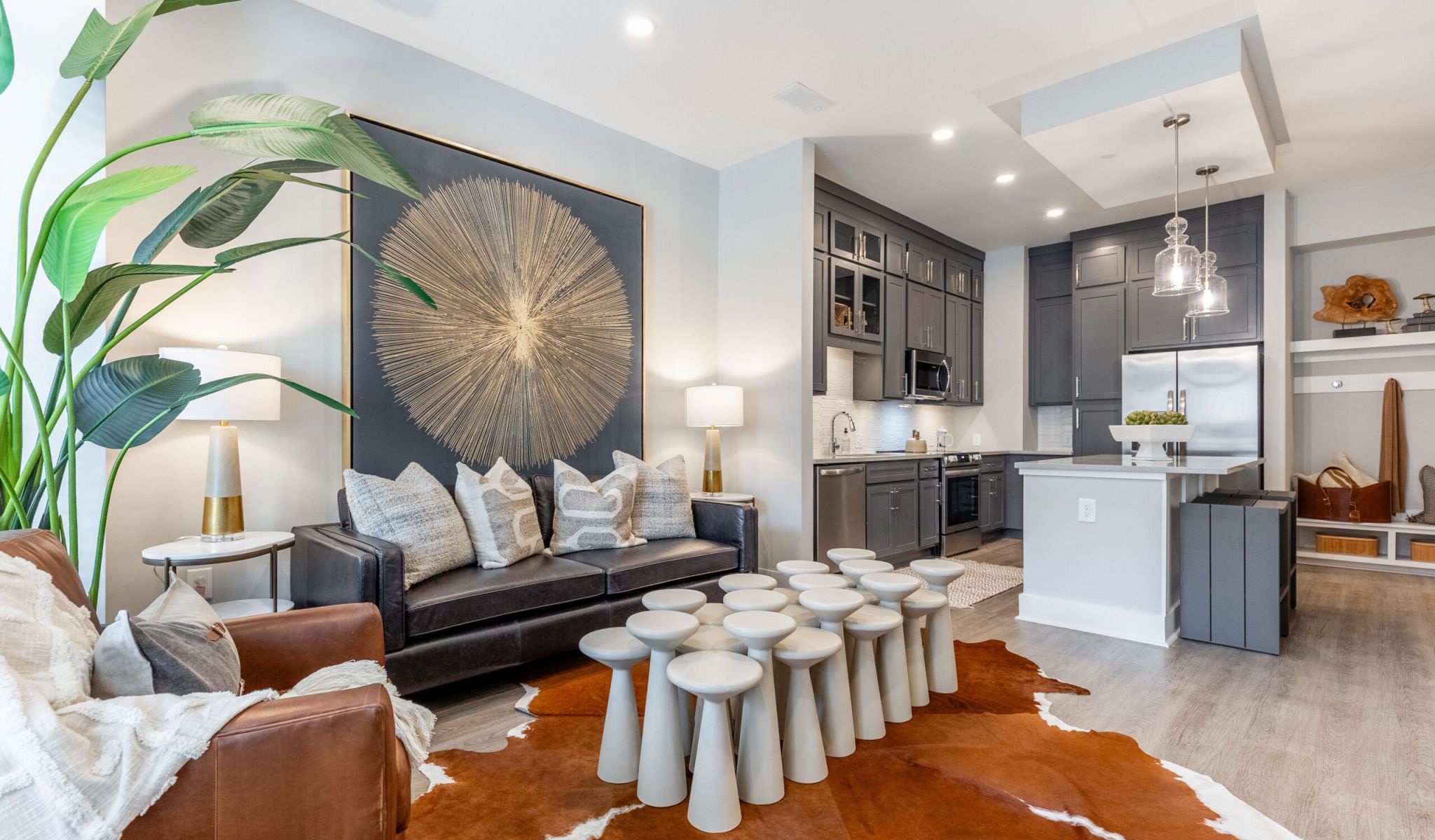 McEwen Apartments furnished living room with large windows and balcony door