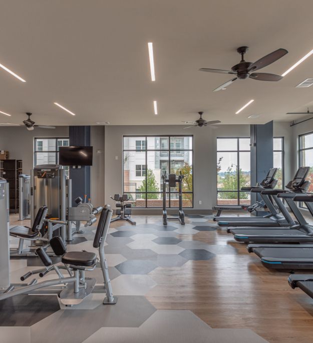 Cardio machines, including Peloton, Stairway, and elliptical at McEwen Northside Apartments