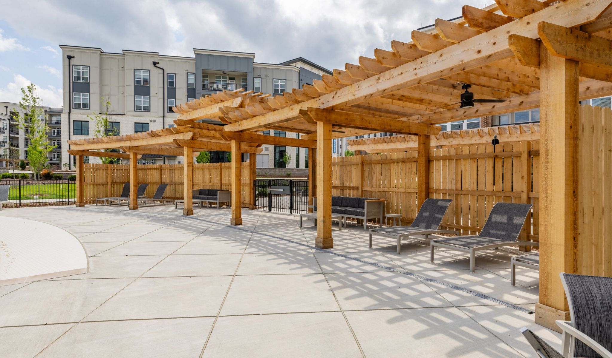 Outdoor poolside wood cabanas with ceiling fans