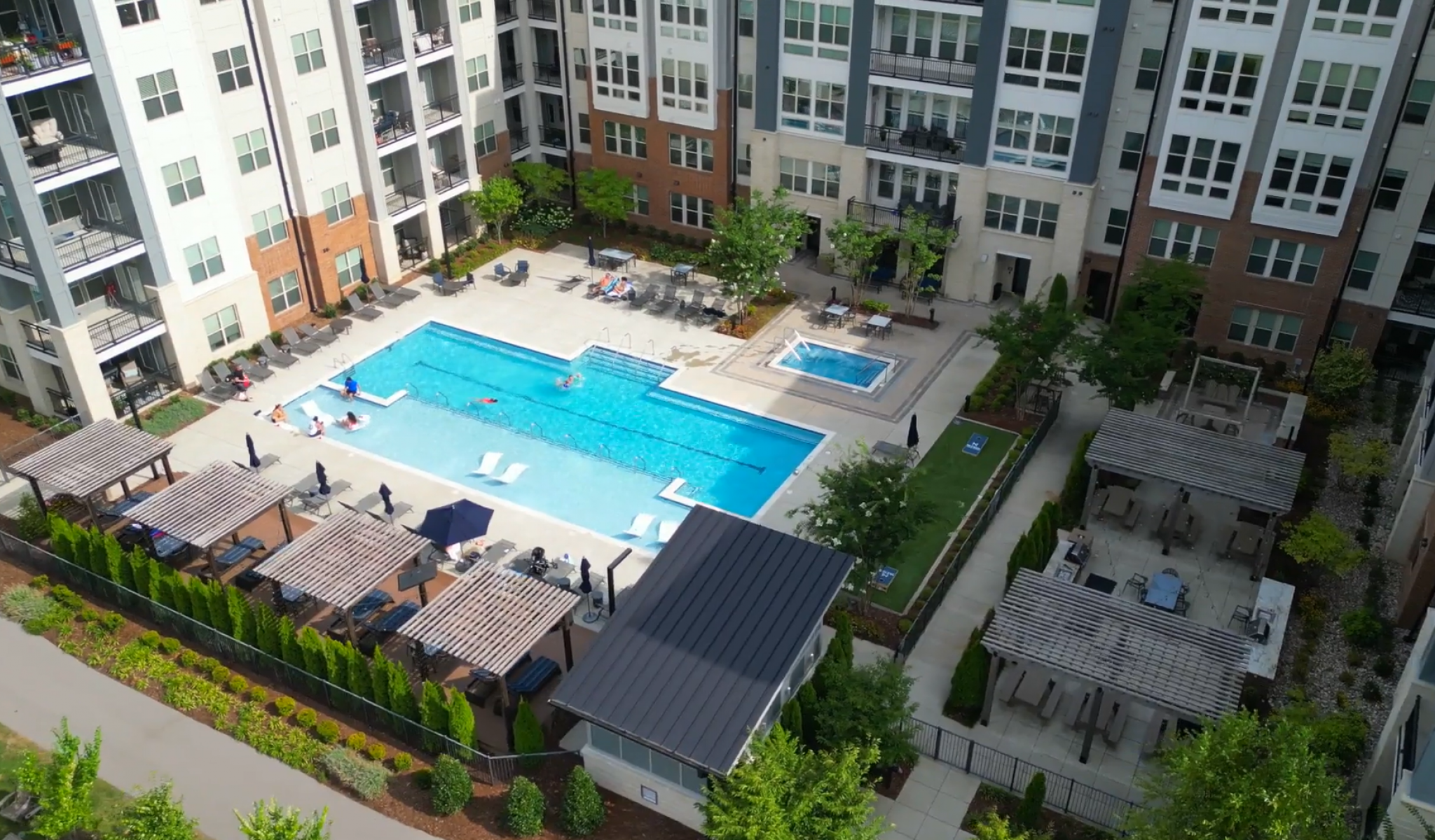 Outdoor apartment pool with sun shelves & built-in seating