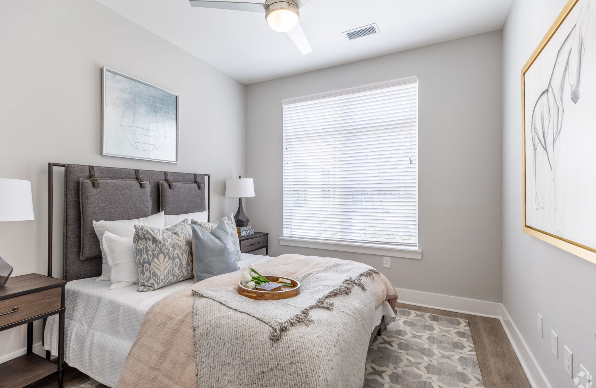 Furnished apartment bedroom with king sized bed at McEwen Northside Apartments