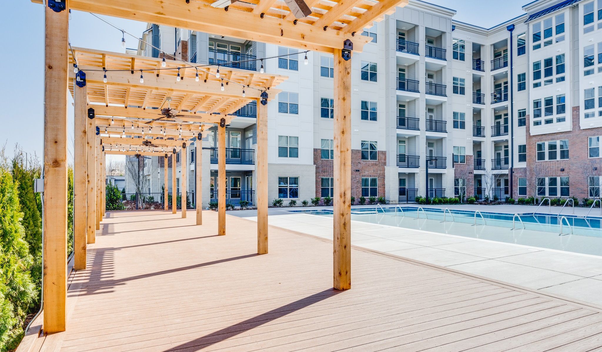 Outdoor poolside wood cabanas with ceiling fans
