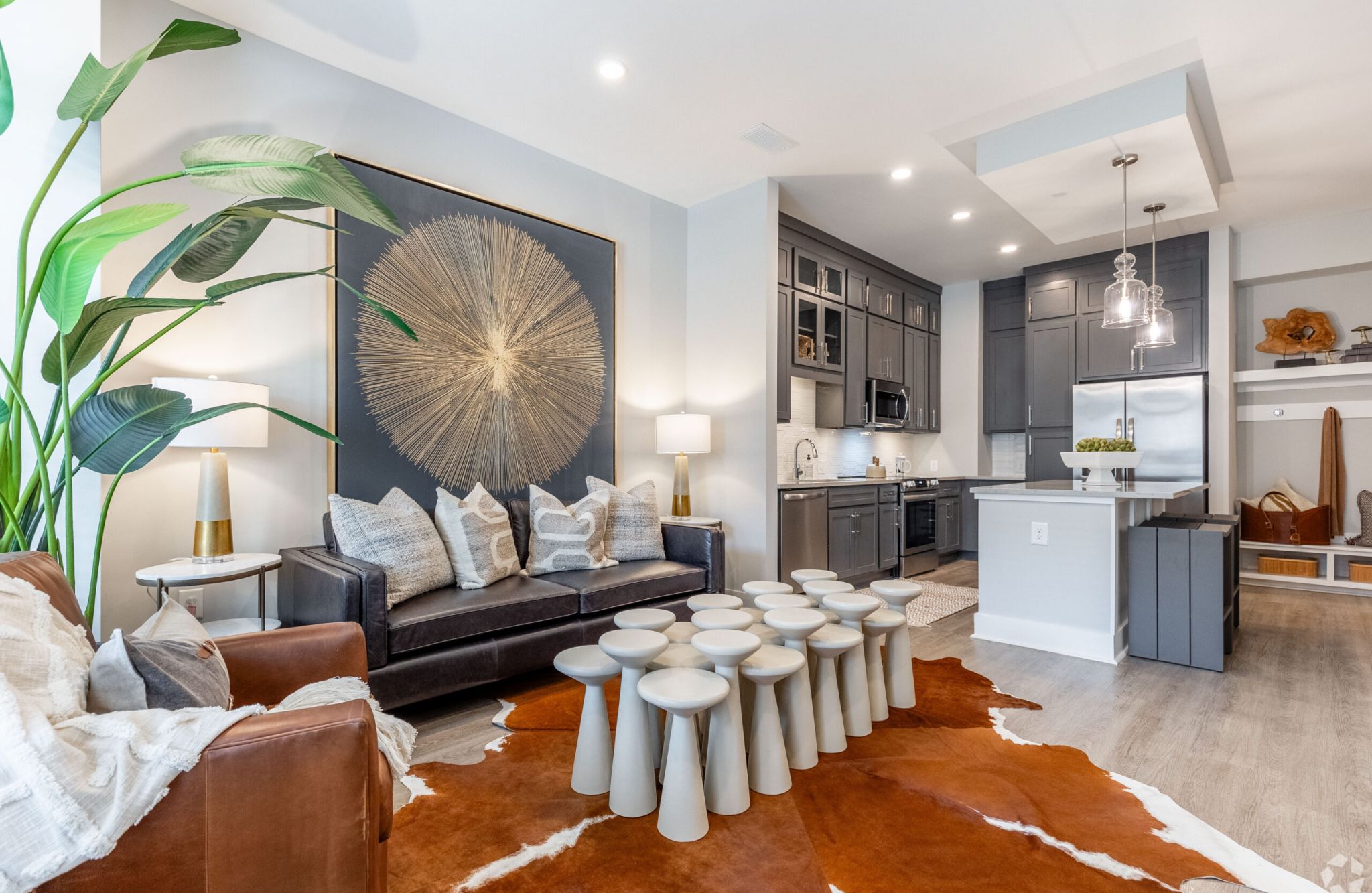 McEwen Apartments furnished living room with large windows and balcony door