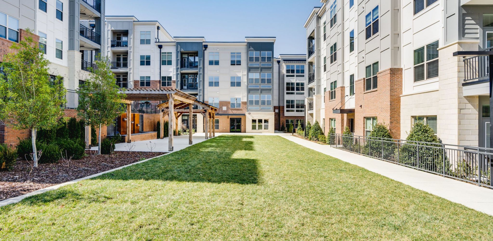 Designer lighting, large island, and designer cabinets at McEwen Northside Apartments