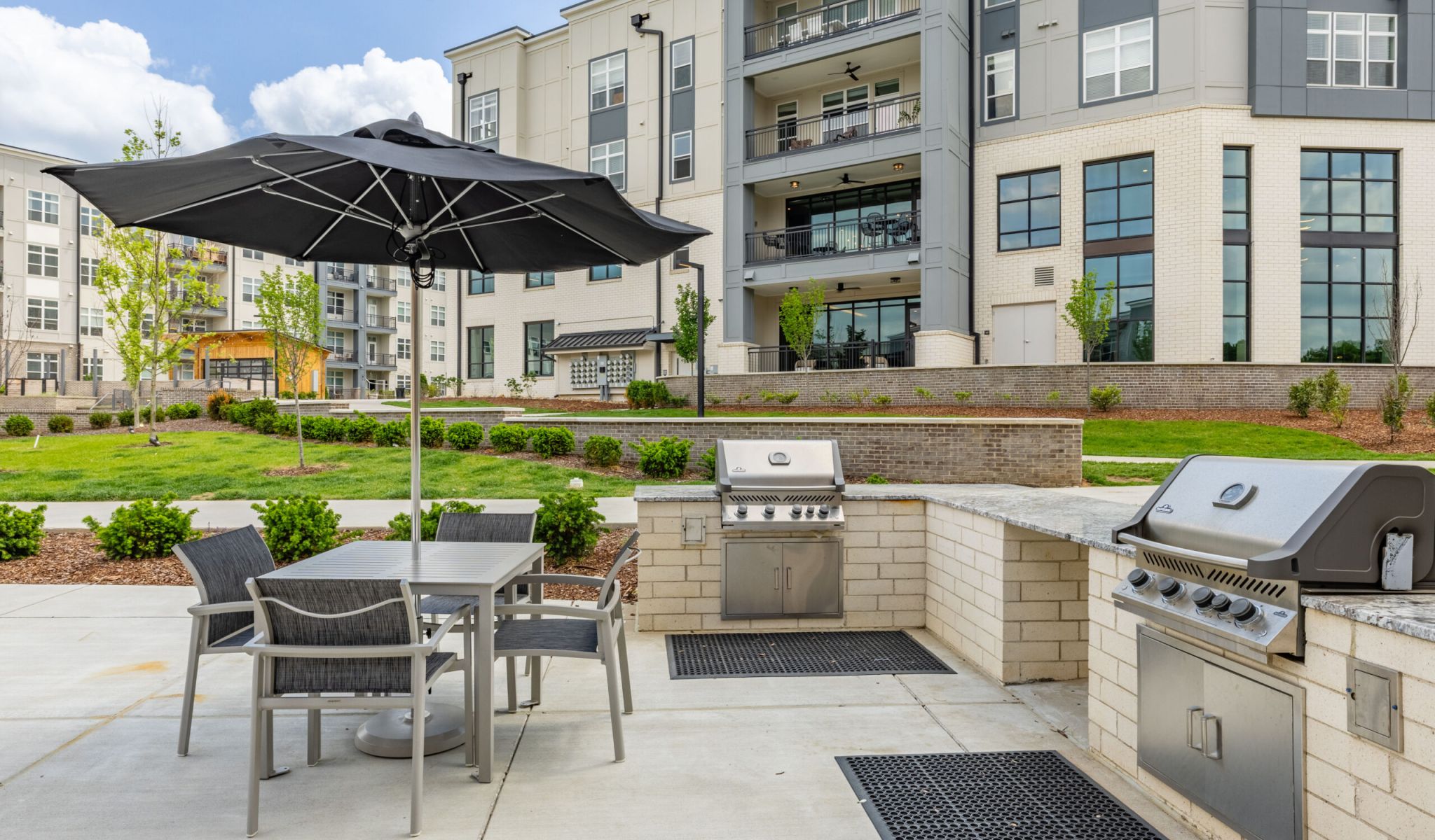 Two outdoor gas grills at McEwen Northside Apartments