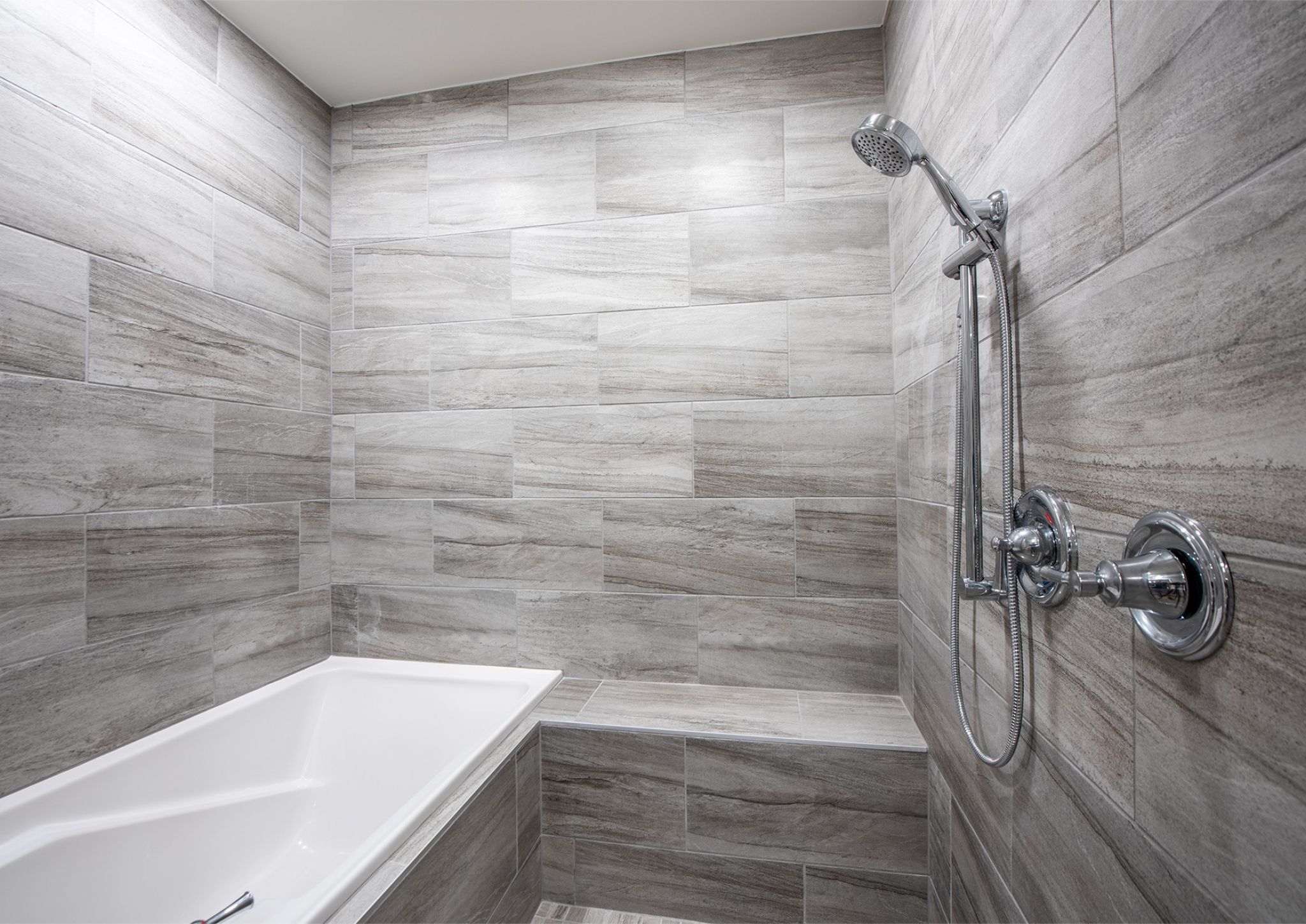 Close up of euro shower and tub combo in apartment bathroom